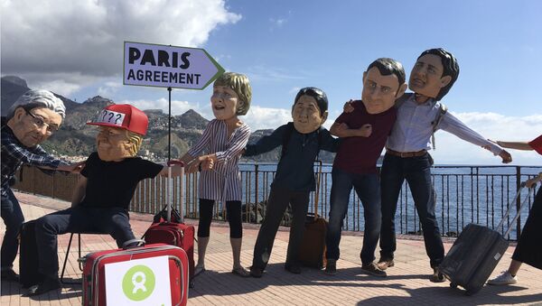 Oxfam activists wearing masks of the leaders of the G7 summit; from left, Italian Premier Paolo Gentiloni, US President Donald Trump, German Chancellor Angela Merkel, Japanese Prime Minister Shinzo Abe, French President Emmanuel Macron and Canadian Prime Minister Justin Trudeau, stage a demonstration in Giardini Naxos, near the venue of the G7 summit in the Sicilian town of Taormina, southern Italy, Friday, May 26, 2017 - Sputnik International
