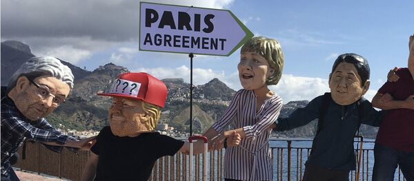 Oxfam activists wearing masks of the leaders of the G7 summit; from left, Italian Premier Paolo Gentiloni, US President Donald Trump, German Chancellor Angela Merkel, Japanese Prime Minister Shinzo Abe, French President Emmanuel Macron and Canadian Prime Minister Justin Trudeau, stage a demonstration in Giardini Naxos, near the venue of the G7 summit in the Sicilian town of Taormina, southern Italy, Friday, May 26, 2017 - Sputnik International