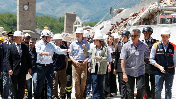 Canada's Prime Minster Justin Trudeau and his wife Sophie Gregoire Trudeau listen to the President of the Province of Rome Nicola Zingaretti during his visit to the town of Amatrice, which was levelled after an earthquake last year, in central Italy, May 28, 2017 - Sputnik International