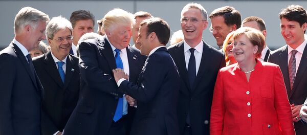 From L-R, Belgium's King Philipe, Italian Prime Minister Paolo Gentiloni, U.S. President Donald Trump who shakes hands with French President Emmanuel Macron, NATO Secretary General Jens Stoltenberg, Dutch Prime Minster Mark Rutte, German Chancellor Angela Merkel, and Canada's Prime Minister Justin Trudeau gather with NATO member leaders to pose for a family picture before the start of their summit in Brussels, Belgium, May 25, 2017 - Sputnik International