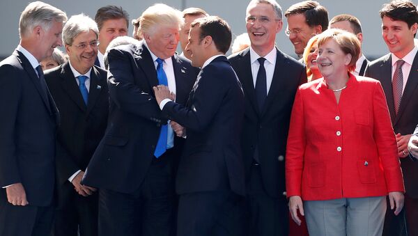 From L-R, Belgium's King Philipe, Italian Prime Minister Paolo Gentiloni, U.S. President Donald Trump who shakes hands with French President Emmanuel Macron, NATO Secretary General Jens Stoltenberg, Dutch Prime Minster Mark Rutte, German Chancellor Angela Merkel, and Canada's Prime Minister Justin Trudeau gather with NATO member leaders to pose for a family picture before the start of their summit in Brussels, Belgium, May 25, 2017 - Sputnik International