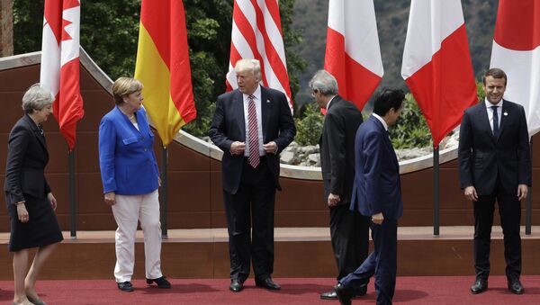 U.S. President Donald Trump, center, stands with other G7 leaders as they prepare for a group photo during the G7 Summit in the Ancient Theatre of Taormina ( 3rd century BC) in the Sicilian citadel of Taormina, Italy, Friday, May 26, 2017 - Sputnik International