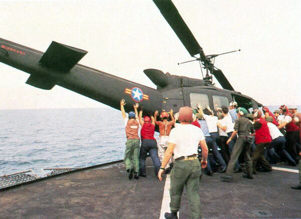 A South Vietnamese UH-1H is pushed overboard to make room for a Cessna O-1 landing A South Vietnamese UH-1H is pushed overboard to make room for a Cessna O-1 landing - Sputnik International
