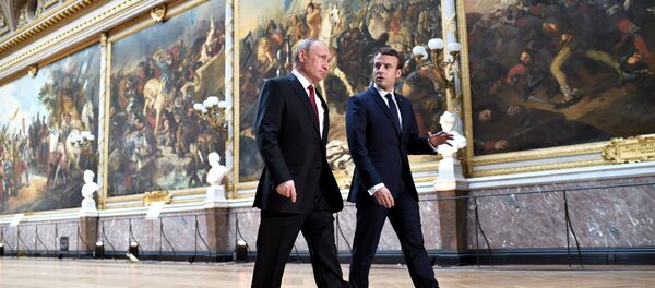 French President Emmanuel Macron (R) speaks to Russian President Vladimir Putin (L) in the Galerie des Batailles (Gallery of Battles) as they arrive for a joint press conference at the Chateau de Versailles before the opening of an exhibition marking 300 years of diplomatic ties between the two countries in Versailles, France, May 29, 2017 French President Emmanuel Macron (R) speaks to Russian President Vladimir Putin (L) in the Galerie des Batailles (Gallery of Battles) as they arrive for a joint press conference at the Chateau de Versailles before the opening of an exhibition marking 300 years of diplomatic ties between the two countries in Versailles, France, May 29, 2017 - Sputnik International