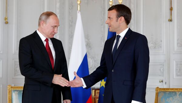French President Emmanuel Macron shakes hands Russian President Vladimir Putin (L) at the Chateau de Versailles as they meet for talks before the opening of an exhibition marking 300 years of diplomatic ties between the two countyies in Versailles, France, May 29, 2017 - Sputnik International