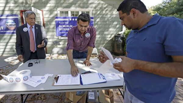 FILE - In this Sept. 23, 2016, file photo, Dr. Mohammad Ali Chaudry, left, president of the Islamic Society of Basking Ridge, N.J., and Shawn Butt, center, of Piscataway, N.J., provide voter registration information to Shahul Feroze, right, of South Brunswick, N.J., after a prayer service at the Bernards Township Community Center in Basking Ridge, N.J. Bernards Township, N.J., will pay $3.25 million to the Islamic Society of Basking Ridge to settle a lawsuit over the township's denial of a permit to build a mosque, the U.S. Justice Department announced Tuesday, May 30, 2017 - Sputnik International