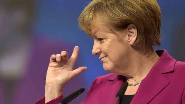 German Chancellor and chairwoman of the German Christian Democrats, CDU, Angela Merkel, points with her fingers during a visit to the convention venue prior to the 27. party convention in Cologne, Germany, Monday, Dec. 8, 2014. - Sputnik International