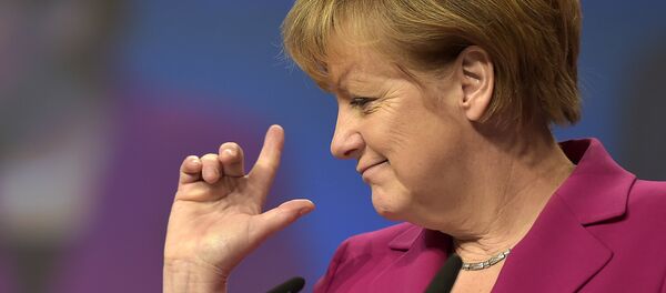 German Chancellor and chairwoman of the German Christian Democrats, CDU, Angela Merkel, points with her fingers during a visit to the convention venue prior to the 27. party convention in Cologne, Germany, Monday, Dec. 8, 2014. - Sputnik International