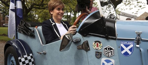 Scotland's First Minister and SNP leader Nicola Sturgeon sits in the driving seat of a Midge car during a campaign visit to Moffat, Scotland, on Friday May 19, 2017. Scotland's First Minister and SNP leader Nicola Sturgeon sits in the driving seat of a Midge car during a campaign visit to Moffat, Scotland, on Friday May 19, 2017. - Sputnik International