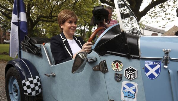 Scotland's First Minister and SNP leader Nicola Sturgeon sits in the driving seat of a Midge car during a campaign visit to Moffat, Scotland, on Friday May 19, 2017. - Sputnik International