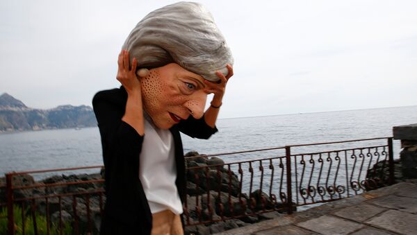 A protester wears a mask depicting Britain's Prime Minister Theresa May during a demonstration organised by Oxfam in Giardini Naxos, Sicily, Italy, May 25, 2017. - Sputnik International