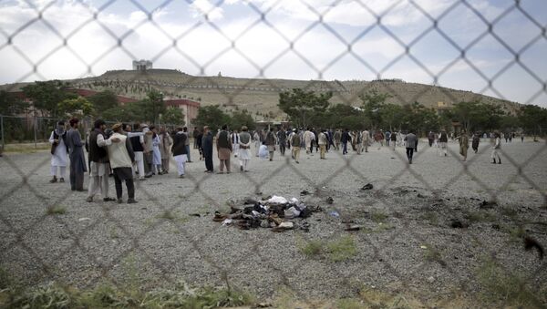 Men walk at the site of three suicide attacks during a funeral ceremony, in Kabul, Afghanistan - Sputnik International