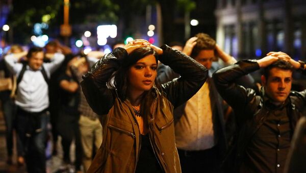 People leave the area with their hands up after an incident near London Bridge in London, Britain June 4, 2017 - Sputnik International