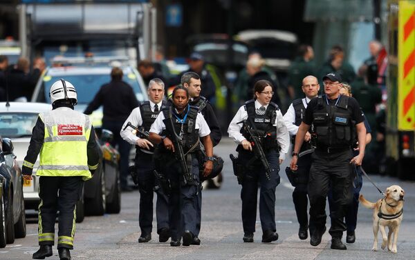 Armed police officers walk outside Borough Market after a terror attack in London, Britain. - Sputnik International