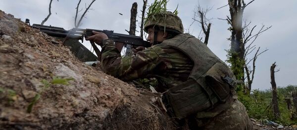A Ukrainian serviceman fires a machine-gun at his position on the front line at the industrial zone of the government-held town of Avdiyivka, Ukraine, May 22, 2017 A Ukrainian serviceman fires a machine-gun at his position on the front line at the industrial zone of the government-held town of Avdiyivka, Ukraine, May 22, 2017 - Sputnik International