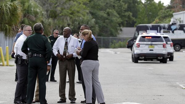 Authorities confer near the scene of a shooting where they said there were multiple fatalities in an industrial area near Orlando, Fla., Monday, June 5, 2017 - Sputnik International
