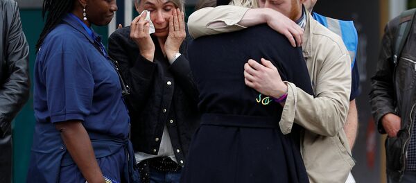 People react in front of floral tributes on the south side of London Bridge near Borough Market after an attack left 7 people dead and dozens of injured in London, Britain, June 5, 2017. People react in front of floral tributes on the south side of London Bridge near Borough Market after an attack left 7 people dead and dozens of injured in London, Britain, June 5, 2017. - Sputnik International
