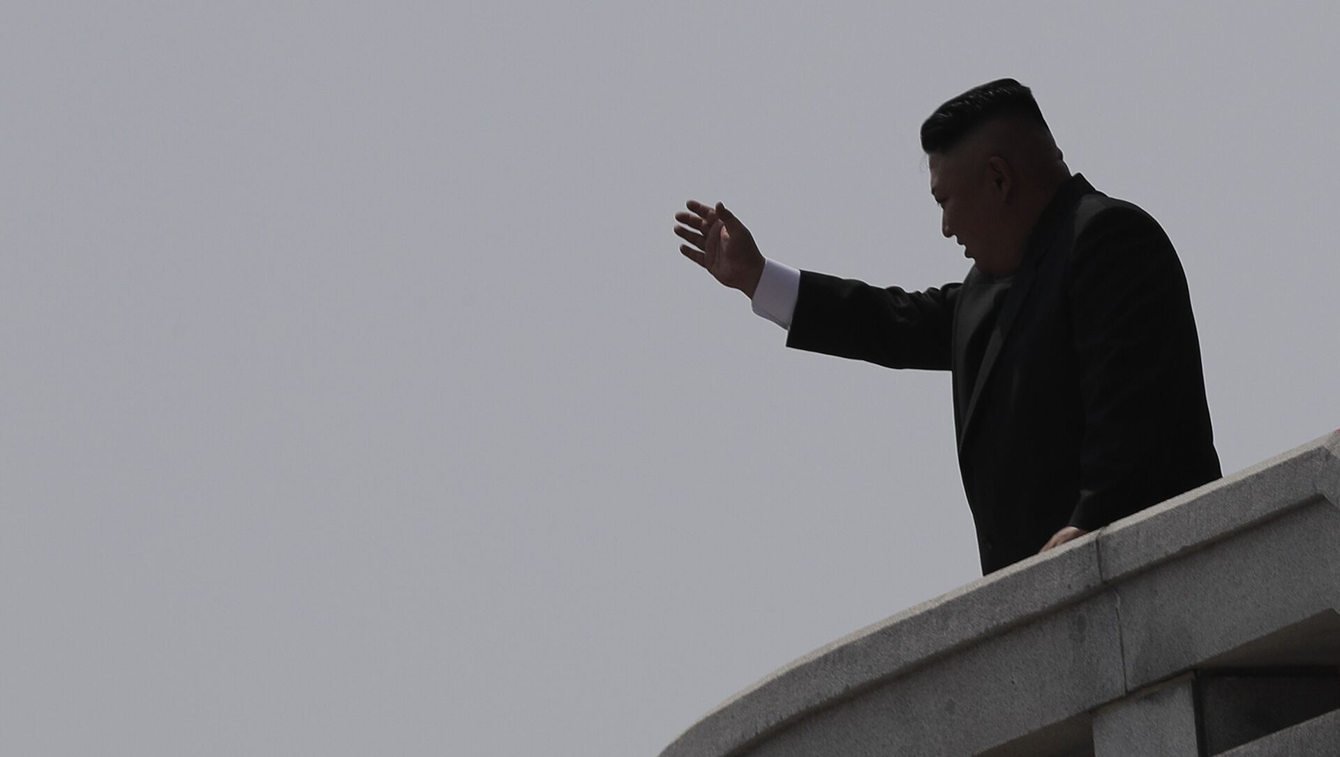 North Korean leader Kim Jong Un is seen in silhouette as he waves during a military parade in Pyongyang, North Korea  - Sputnik International, 1920, 20.06.2021