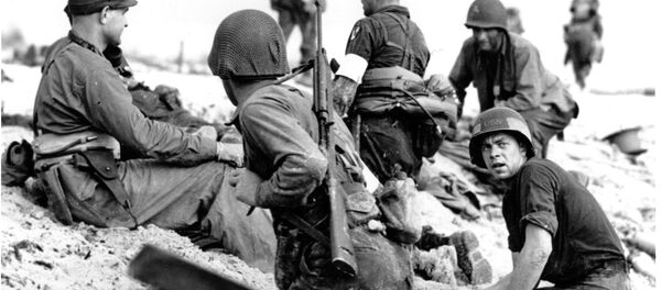 In this June 6, 1944 file photo, first wave beach battalion Ducks lay low under the fire of Nazi guns on the beach of southern France on D-Day, June 6, 1944 during World War II. One invader operates a walkie talkie radio directing other landing craft to the safest spots for unloading their parties of fighting men. In this June 6, 1944 file photo, first wave beach battalion Ducks lay low under the fire of Nazi guns on the beach of southern France on D-Day, June 6, 1944 during World War II. One invader operates a walkie talkie radio directing other landing craft to the safest spots for unloading their parties of fighting men. - Sputnik International