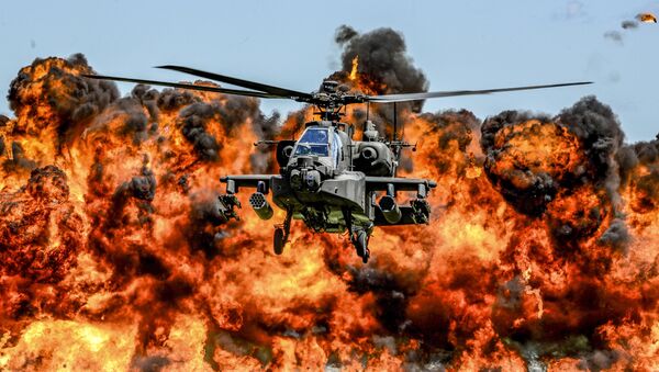 An AH-64D Apache attack helicopter flies in front of a wall of fire during the South Carolina National Guard Air and Ground Expo at McEntire Joint National Guard Base, South Carolina, U.S. on May 6, 2017 - Sputnik International