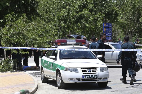 The body of a suspected terrorist, at background left, lies on the ground while police control the scene at the shrine of late Iranian revolutionary founder Ayatollah Khomeini, just outside Tehran, Iran, Wednesday, June 7, 2017 The body of a suspected terrorist, at background left, lies on the ground while police control the scene at the shrine of late Iranian revolutionary founder Ayatollah Khomeini, just outside Tehran, Iran, Wednesday, June 7, 2017 - Sputnik International