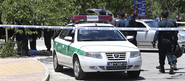 The body of a suspected terrorist, at background left, lies on the ground while police control the scene at the shrine of late Iranian revolutionary founder Ayatollah Khomeini, just outside Tehran, Iran, Wednesday, June 7, 2017 The body of a suspected terrorist, at background left, lies on the ground while police control the scene at the shrine of late Iranian revolutionary founder Ayatollah Khomeini, just outside Tehran, Iran, Wednesday, June 7, 2017 - Sputnik International