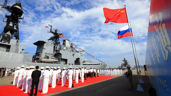 In this photo released by China's Xinhua News Agency, officers and soldiers of China's People's Liberation Army (PLA) Navy hold a welcome ceremony as a Russian naval ship arrives in port in Zhanjiang in southern China's Guangdong Province, Monday, Sept. 12, 2016 - Sputnik International