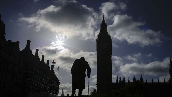 A statue of former British Prime Minister Winston Churchill silhouettes in front of the Houses of Parliament the day after Britain's national elections in London, Friday, June 9, 2017. - Sputnik International