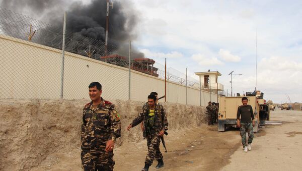 In this March 9, 2016 file photo, smoke rises from a building, where Taliban insurgents hide during a fire fight with Afghan security forces, in Helmand province, south west Afghanistan.  - Sputnik International