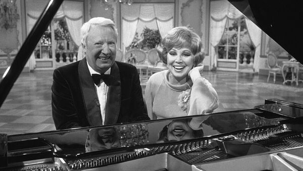 Former British Prime Minister Edward Heath and West German opera singer Anneliese Rothenberger pose sitting at a piano during an interval in shooting for a Television show in Hamburg, West Germany on May 17, 1977. - Sputnik International