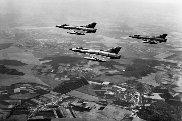This file photo taken on March 1, 1967 shows Israeli airforce Dassault Mirage III fighters flying over Israel during a training three months ahead of the Six-Day Arab-Israeli war.  - Sputnik International