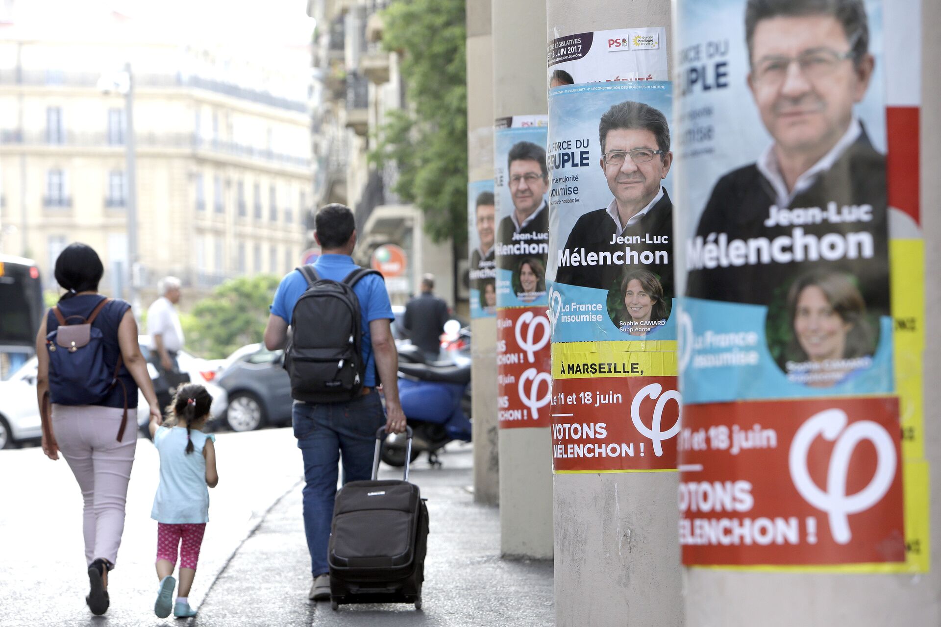 People walk past near posters of Jean-Luc Melenchon, a former hard-left candidate in the first round of the presidential election, candidate for the upcoming legislative elections, at the Belsunce district, in Marseille, southern France - Sputnik International, 1920, 19.04.2022