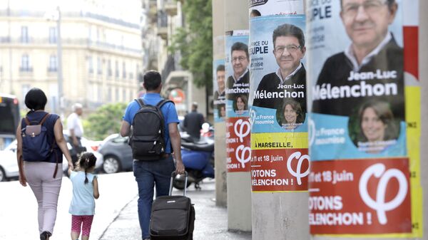People walk past near posters of Jean-Luc Melenchon, a former hard-left candidate in the first round of the presidential election, candidate for the upcoming legislative elections, at the Belsunce district, in Marseille, southern France - Sputnik International