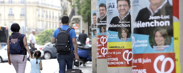People walk past near posters of Jean-Luc Melenchon, a former hard-left candidate in the first round of the presidential election, candidate for the upcoming legislative elections, at the Belsunce district, in Marseille, southern France People walk past near posters of Jean-Luc Melenchon, a former hard-left candidate in the first round of the presidential election, candidate for the upcoming legislative elections, at the Belsunce district, in Marseille, southern France - Sputnik International