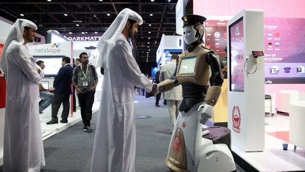A visitor shakes hands with an operational robot policeman at the opening of the 4th Gulf Information Security Expo and Conference (GISEC) in Dubai, United Arab Emirates, May 22, 2017. Picture taken May 22, 2017 - Sputnik International