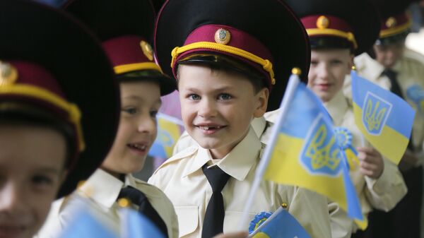 Seven-year old cadets hold Ukrainian flags as they attend a ceremony on the occasion of the first day of school at a cadet lyceum in Kiev, Ukraine, Thursday, Sept. 1, 2016 - Sputnik International