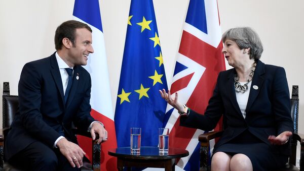 Britain's Prime Minister Theresa May and French President Emmanuel Macron talk during a bilateral meeting at the G7 Summit in Taormina, Sicily, Italy, May 26, 2017. - Sputnik International