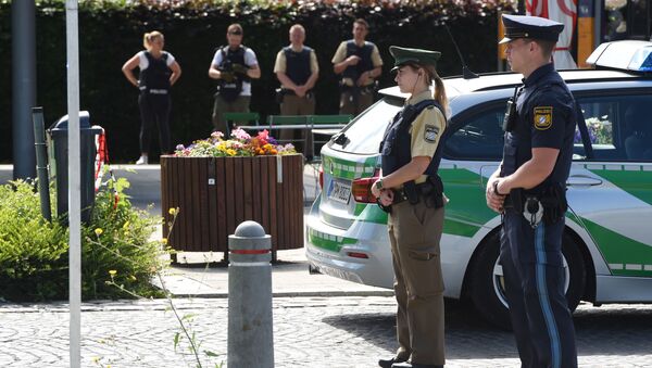 Police officers secure the area around a commuter rail station in Unterfoehring near Munich, southern Germany, where shots were fired on June 13, 2017 - Sputnik International