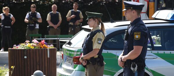 Police officers secure the area around a commuter rail station in Unterfoehring near Munich, southern Germany, where shots were fired on June 13, 2017 - Sputnik International