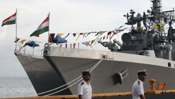 Indian sailors walk beside Indian Navy ships, from left, INS Ranvijay (D55), a Rajput class destroyer, and INS Saptura, a Shivalik-class stealth multi-role frigate, as they arrive at Berth 15, South Harbour, in Manila, Philippines on Wednesday, June 12, 2013 - Sputnik International