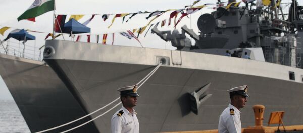 Indian sailors walk beside Indian Navy ships, from left, INS Ranvijay (D55), a Rajput class destroyer, and INS Saptura, a Shivalik-class stealth multi-role frigate, as they arrive at Berth 15, South Harbour, in Manila, Philippines on Wednesday, June 12, 2013 - Sputnik International