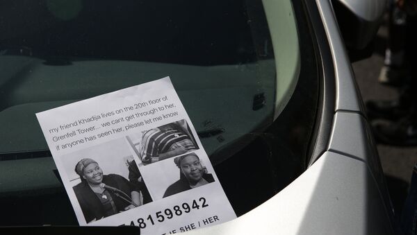 A flyer for a missing person Khadija Saye, is seen on a car near a temporary casualty bureau opened for people affected by the fire at Grenfell Tower, a residential block of flats on June 14, 2017 in west London, as firefighters continue to control a fire. - Sputnik International