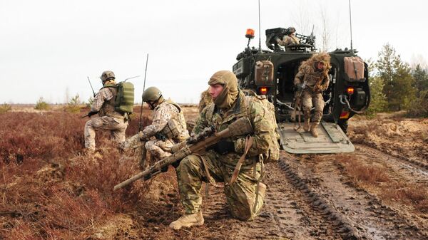 U.S. Army snipers assigned to Headquarters and Headquarters Troop, 2nd Cavalry Regiment, and Latvian land forces snipers, pull perimeter security during a combined live-fire exercise with the Latvian land forces, part of Operation Atlantic Resolve in Adazi training area, Latvia, March 6, 2015 - Sputnik International