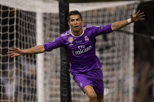 Real Madrid's Portuguese striker Cristiano Ronaldo celebrates after scoring their third goal during the UEFA Champions League final football match between Juventus and Real Madrid at The Principality Stadium in Cardiff, south Wales Real Madrid's Portuguese striker Cristiano Ronaldo celebrates after scoring their third goal during the UEFA Champions League final football match between Juventus and Real Madrid at The Principality Stadium in Cardiff, south Wales - Sputnik International