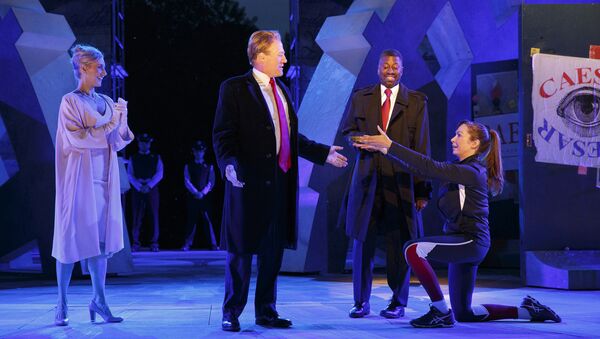In this May 21, 2017 photo provided by The Public Theater, Tina Benko, left, portrays Melania Trump in the role of Caesar's wife, Calpurnia, and Gregg Henry, center left, portrays President Donald Trump in the role of Julius Caesar during a dress rehearsal of The Public Theater's Free Shakespeare in the Park production of Julius Caesar, in New York. Rounding out the cast on stage is Teagle F. Bougere as Casca, and Elizabeth Marvel, right, as Marc Anthony. - Sputnik International
