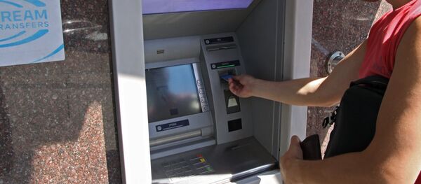 A city resident at a cash dispenser operated by the Central Republican Bank in Donetsk - Sputnik International