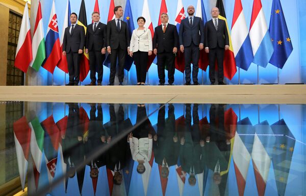 (L-R) Luxembourg's Prime Minister Xavier Bettel, Slovakia's Prime Minister Robert Fico, Dutch Prime Minister Mark Rutte, Poland's Prime Minister Beata Szydlo, Hungary's Prime Minister Viktor Orban, Belgium's Prime Minister Charles Michel and Czech Prime Minister Bohuslav Sobotka pose for a family photo during a meeting of the prime ministers of the Visegrad Group and Benelux countries in Warsaw, Poland, June 19, 2017 (L-R) Luxembourg's Prime Minister Xavier Bettel, Slovakia's Prime Minister Robert Fico, Dutch Prime Minister Mark Rutte, Poland's Prime Minister Beata Szydlo, Hungary's Prime Minister Viktor Orban, Belgium's Prime Minister Charles Michel and Czech Prime Minister Bohuslav Sobotka pose for a family photo during a meeting of the prime ministers of the Visegrad Group and Benelux countries in Warsaw, Poland, June 19, 2017 - Sputnik International
