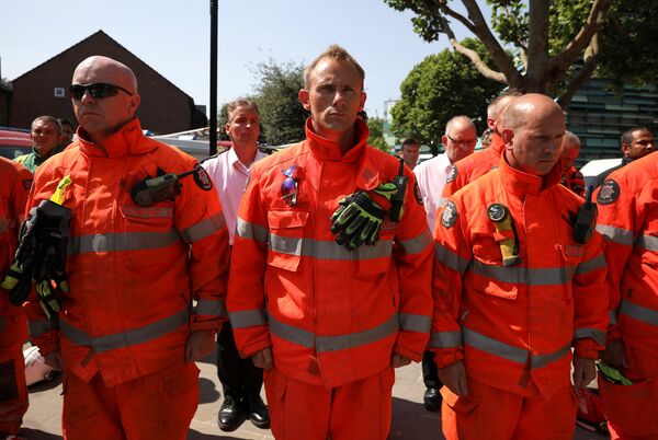 Members of the emergency services attend a minute's silence for the victims of the Grenfell Tower fire near the site of the blaze in North Kensington, London, Britain, June 19, 2017.  - Sputnik International