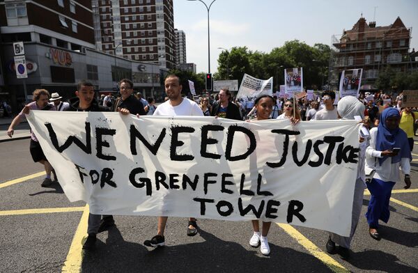 Demonstrators march during a protest about the Grenfell Tower fire, in London, Britain, June 21, 2017 Demonstrators march during a protest about the Grenfell Tower fire, in London, Britain, June 21, 2017 - Sputnik International