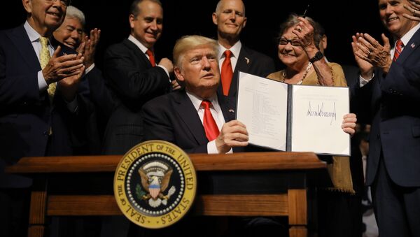 U.S. President Donald Trump is applauded after signing an Executive Order on US-Cuba policy at the Manuel Artime Theater in Miami, Florida, U.S., June 16, 2017 - Sputnik International
